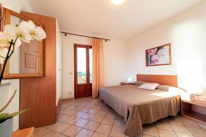 a bedroom with a large bed and a window at Da Angiolina in Marciana