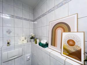 a bathroom with a framed picture of a rainbow at STYLISCHE ZENTRALE WOHNUNG MIT KÜCHE UND PARKPLATZ IN SEITENSTRAẞE in Deggendorf