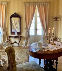 a living room with a table with candles on it at Nääs Slott in Floda