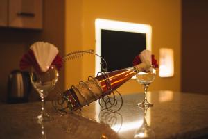 a bottle of wine on a table with two glasses at Hotel Liana in Ulcinj