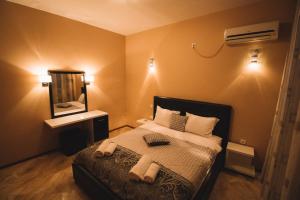 a bedroom with a bed with towels on it at Hotel Liana in Ulcinj +18 photos
