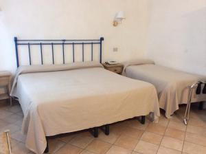 Postel nebo postele na pokoji v ubytování Albergo Cannon d'Oro