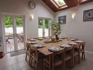 a dining room with a large wooden table and chairs at Four Seasons - Hw7432 in Tal-gareg