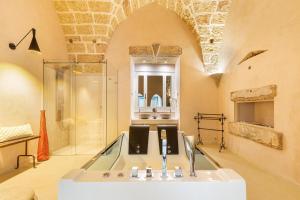 a bathroom with a sink and a shower in a room at Le Mule Suite and Rooms - Specchia in Specchia