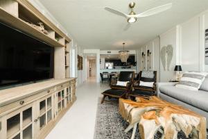 a living room with a large flat screen tv at Unit 103 Aruba - 3 Bedroom Ocean Front in Daytona Beach