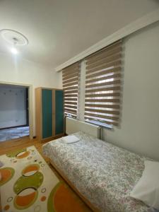 a bedroom with a bed and a large window at Budak Home in Nevşehir