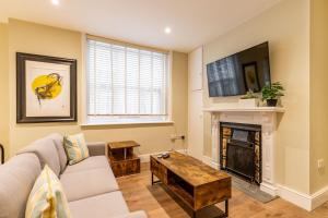 a living room with a couch and a fireplace at Cromer Town Apartment 1 - Norfolk Holiday Properties in Cromer