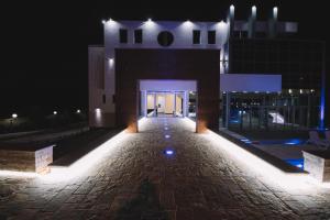 a building with a doorway with lights at night at Hotel Liana in Ulcinj