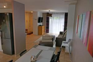 a kitchen and living room with a table and chairs at LES VILLAS PARADIS - Serris, proche Paris & Disneyland in Serris