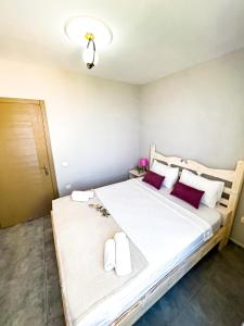 a bedroom with a large bed with red pillows at Just Dream Suites in Kaş