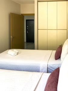 a bedroom with two beds and a closet at Just Dream Suites in Kaş