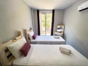 a room with two beds and a window at Just Dream Suites in Kaş