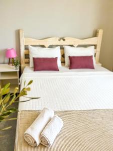 a bedroom with two beds with towels on them at Just Dream Suites in Kaş