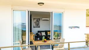 a balcony with a wooden table and chairs at Just Dream Suites in Kaş