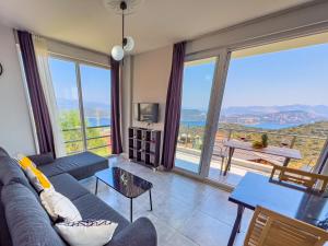a living room with a couch and a view of the ocean at Just Dream Suites in Kaş