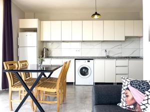 a kitchen and living room with a table and chairs at Just Dream Suites in Kaş