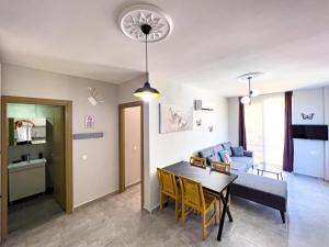 a living room with a table and a couch at Just Dream Suites in Kaş