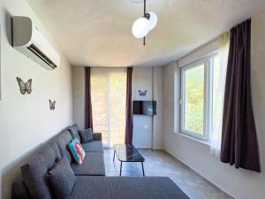 a living room with a couch and a window at Just Dream Suites in Kaş