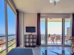 a living room with sliding glass doors leading to a balcony at Just Dream Suites in Kaş