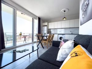 a living room with a couch and a glass table at Just Dream Suites in Kaş