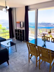 a living room with a glass table and a view of the ocean at Just Dream Suites in Kaş