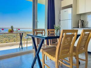 a kitchen and dining room with a table and chairs at Just Dream Suites in Kaş