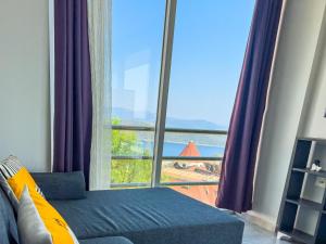 a bedroom with a large window with a view of the ocean at Just Dream Suites in Kaş