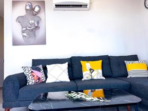 a living room with a blue couch with colorful pillows at Just Dream Suites in Kaş