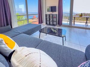 a living room with a blue couch and a table at Just Dream Suites in Kaş