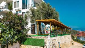 a building with a pavilion on the side of it at Just Dream Suites in Kaş