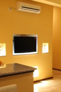 a room with a flat screen tv on a wall at Hotel Liana in Ulcinj