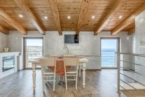 a kitchen with a table and chairs with a view of the ocean at Casa Viktor in Umag