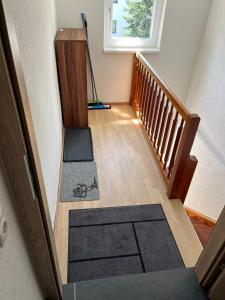 an empty hallway with a stairway with a vacuum at Apartment 2 in Lendorf