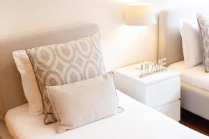 a bedroom with a bed with a pillow on it at São Félix Seaside Oasis in São Félix da Marinha