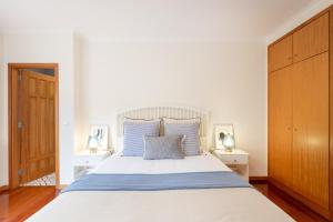 a bedroom with a large bed with two night stands at São Félix Seaside Oasis in São Félix da Marinha