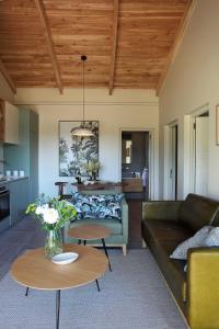 a living room with a couch and a table at Jardin de la Ferme in Franschhoek
