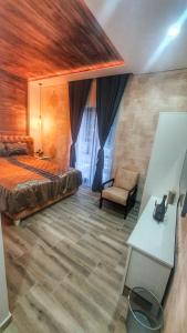 a bedroom with a bed and a chair and a table at Castello Inn in Smederevska Palanka +84 photos