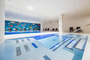 a large swimming pool in a building at Elements Hotel&Spa in Świeradów-Zdrój