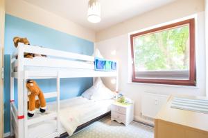 a bedroom with two bunk beds and a desk at Ferienhof Kluvetasch Appartement Nr 3 - Seestern in Rettin