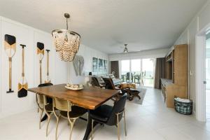 a dining room with a wooden table and chairs at Unit 103 Aruba - 3 Bedroom Ocean Front in Daytona Beach