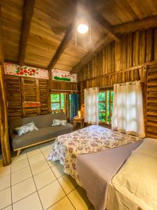a bedroom with a bed and a couch in a room at Cabañas Lamaite in Sámara +37 photos