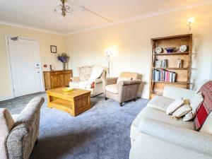 a living room with two couches and a coffee table at Maesbury Manor in Oswestry