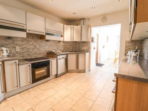a kitchen with stainless steel appliances and a tile floor at Maesbury Manor in Oswestry