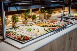 a display case filled with different types of food at Elements Hotel&Spa in Świeradów-Zdrój
