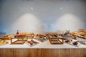 a display case with a bunch of different types of food at Elements Hotel&Spa in Świeradów-Zdrój