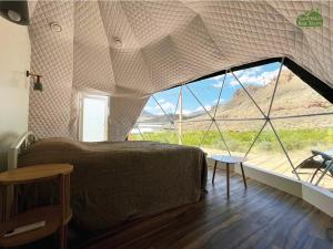 a bedroom with a bed and a large window at Eco Dom Tent in Vedi +20 photos