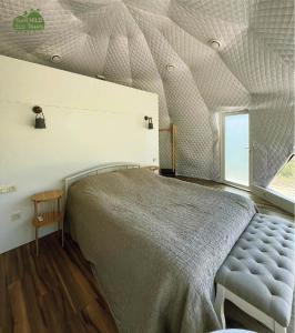 a bedroom with a large bed and a window at Eco Dom Tent in Yerevan