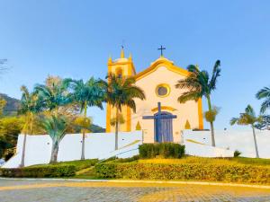 uma igreja com palmeiras em frente em Studios Altos da Igrejinha em Florianópolis