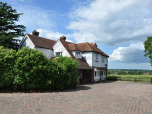 a large white house with a brick driveway at The Orchard in Rye