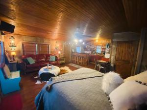 a bedroom with a bed and a couch in a room at 8th St. Cowboy Haus I Biker Friendly I River in Bandera